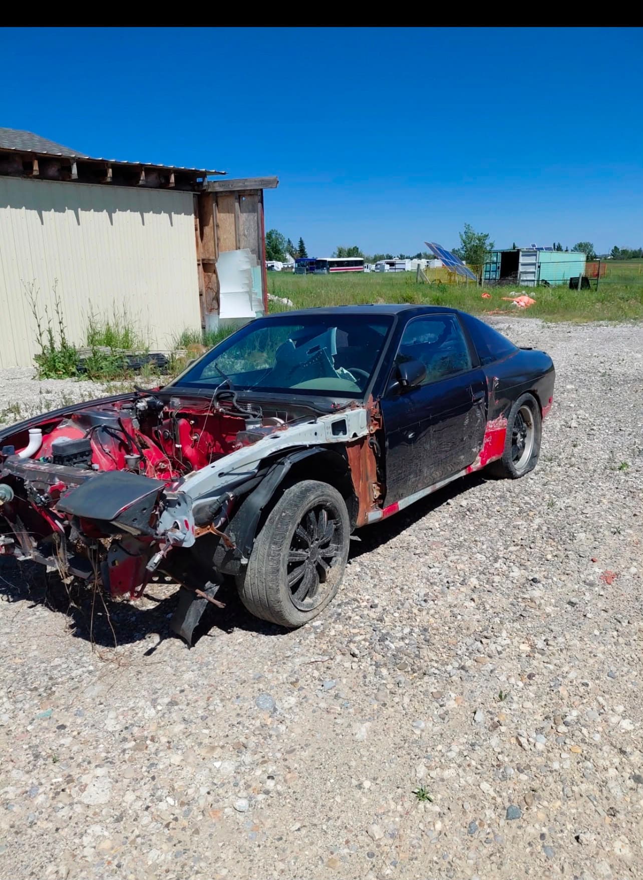 Scrap car being removed by tow truck